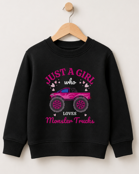Kids "Just A Girl Who Loves Monster Trucks" sweatshirt in black styled on a wooden hanger