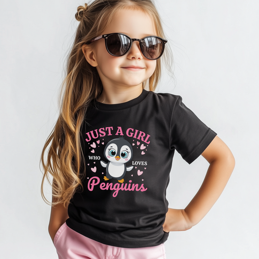 Girl wearing black t-shirt with “Just a Girl Who Loves Penguins” design and pink hearts
