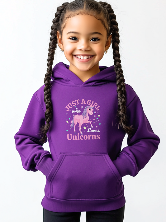 Young girl wearing a purple hoodie featuring a pink and purple unicorn surrounded by stars and hearts with the text “Just a Girl Who Loves Unicorns.”