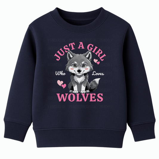 Navy girls sweatshirt with ‘Just A Girl Who Loves Wolves’ slogan and cute grey wolf pup with pink hearts – kids wolf jumper ages 3–13.