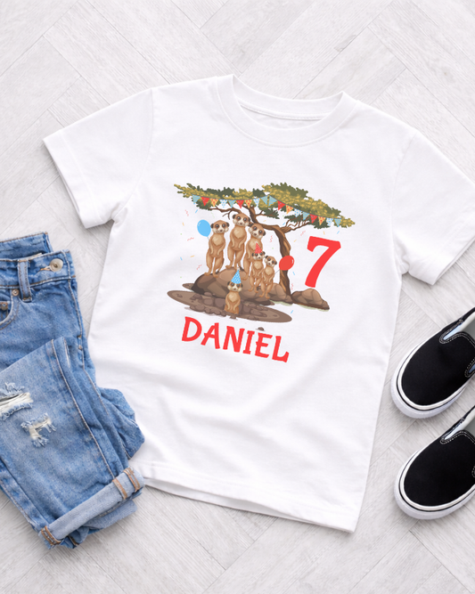Personalised kids 7th birthday meerkat family T-shirt with custom name Daniel, styled with denim shorts and black trainers.
