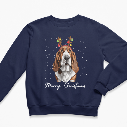 Navy blue kids Christmas crewneck sweatshirt laid flat, featuring a Basset Hound dog graphic with festive reindeer antlers and 'Merry Christmas' written below.
