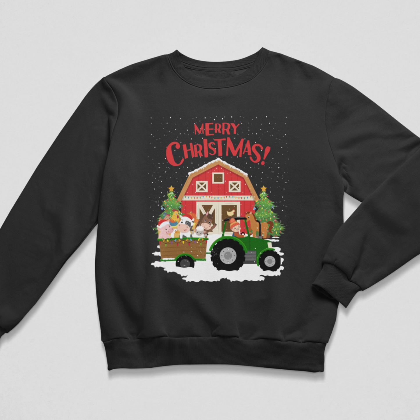Flat lay of a black children's Christmas crewneck sweatshirt featuring a green tractor pulling a cart full of festive farm animals in front of a red barn, with 'Merry Christmas!' written above.