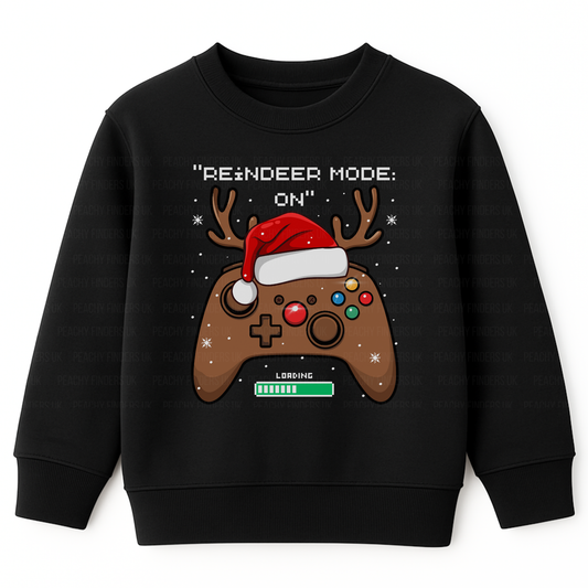 Kids black Christmas jumper with a reindeer-themed gaming controller design and the slogan “Reindeer Mode: ON”