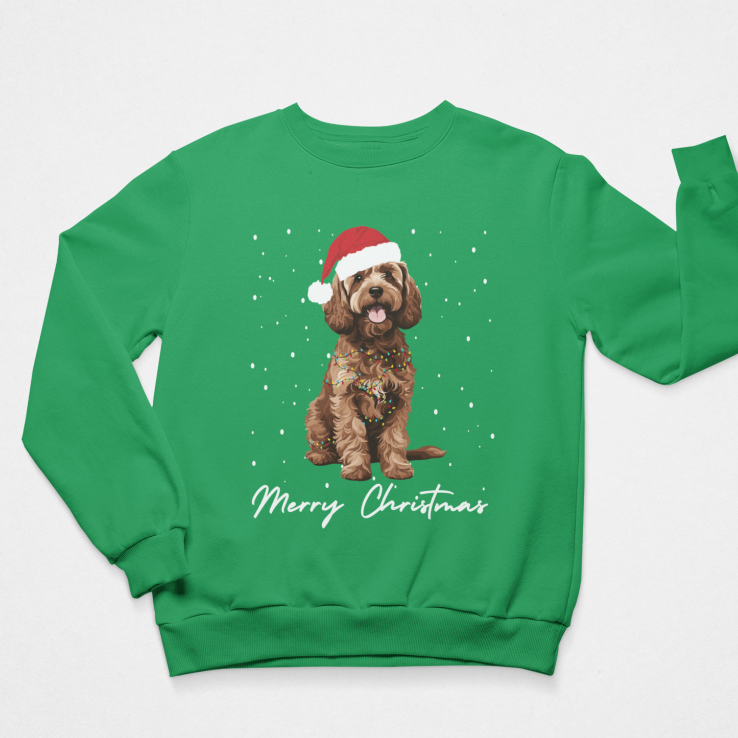 Children's green crewneck sweatshirt featuring a graphic of a brown cockapoo wearing a red Santa hat, with 'Merry Christmas' written in white script below, displayed on a light grey background.
