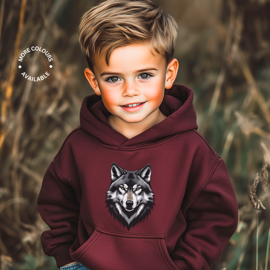 Child wearing a maroon hoodie with a wolf design in a natural setting