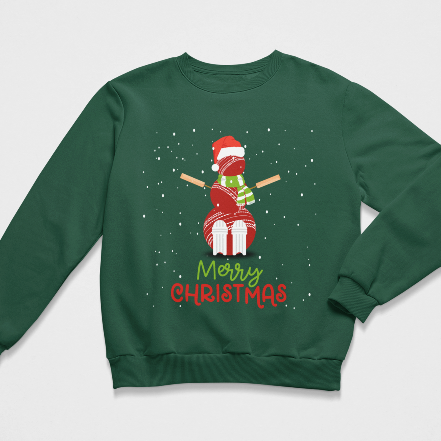A kids dark green crewneck sweatshirt featuring a festive graphic of a snowman made from cricket balls, wearing a Santa hat and scarf, with the text 'Merry Christmas' underneath on a light grey background.