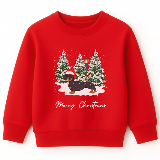 Kids red Christmas sweatshirt featuring a festive dachshund in a Santa hat, surrounded by snowy Christmas trees.