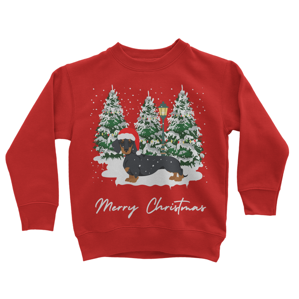 Kids red Christmas sweatshirt featuring a festive dachshund in a Santa hat, standing in front of snowy Christmas trees with a lamp post.