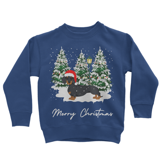Kids Royal Blue Christmas sweatshirt featuring a festive dachshund in a Santa hat, standing in front of snowy Christmas trees with a lamp post.