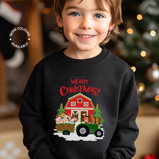 A child wearing a black sweatshirt with a Christmas themed farm and animal graphic, including a barn, trees, and festive decorations.