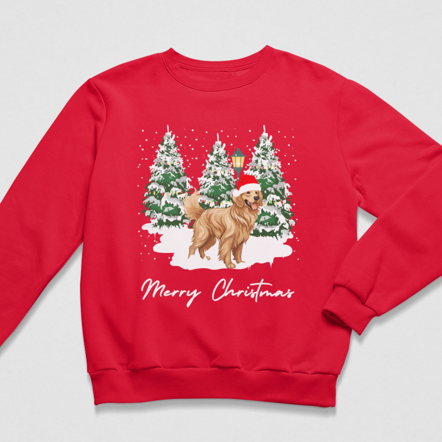 A kids red crewneck sweatshirt featuring a festive Christmas graphic of a golden retriever dog wearing a Santa hat, standing in front of three snow-covered Christmas trees. The text 'Merry Christmas' is printed in white script below the illustration, set against a light gray background.