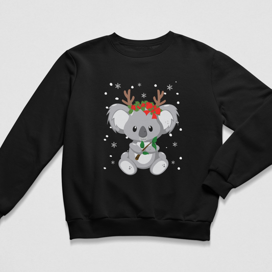 Children’s black Christmas sweatshirt with a centred koala bear design, red floral headpiece, antlers, leafy branch and white snowflakes for a festive winter look.