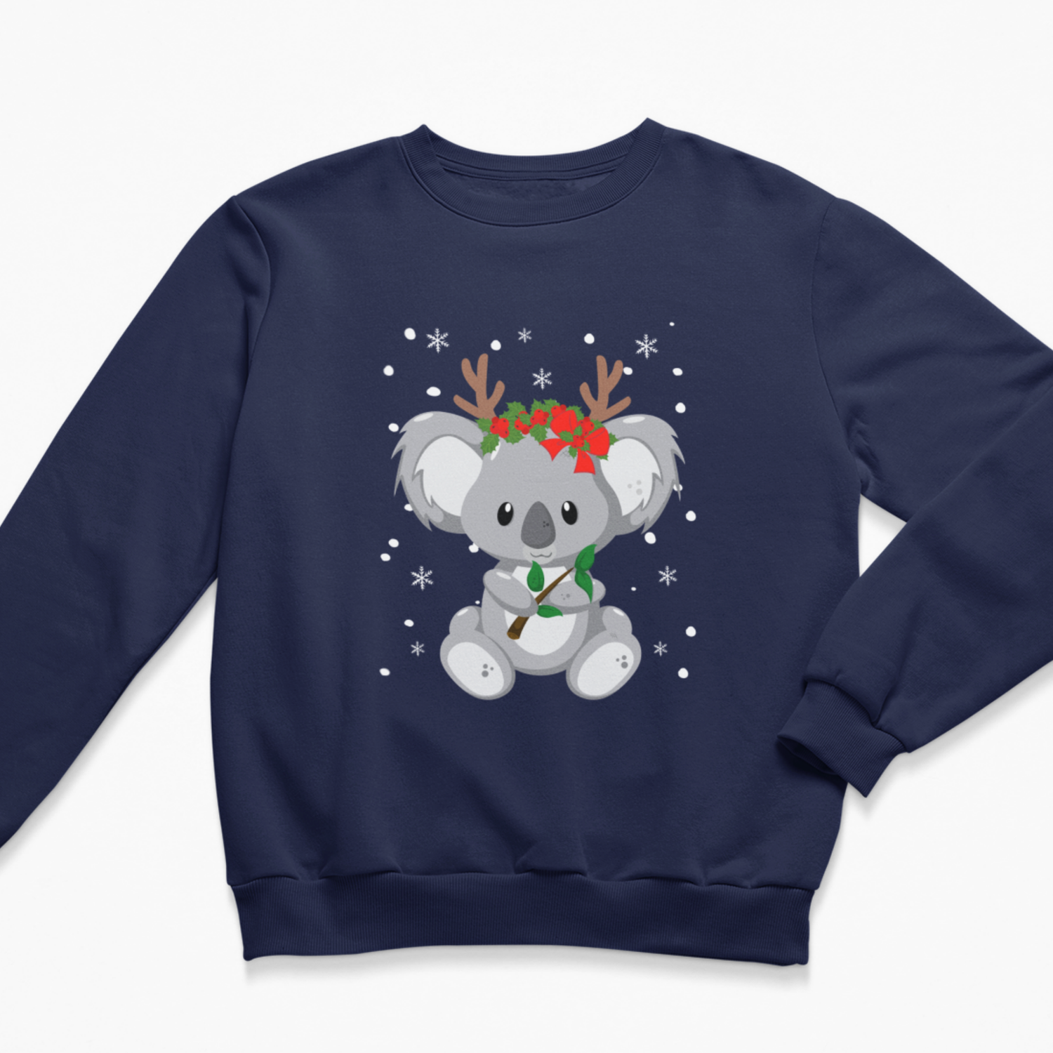Navy blue children’s Christmas jumper with a smiling koala holding a leafy branch, decorated with brown antlers, red poinsettias and falling white winter snowflakes.