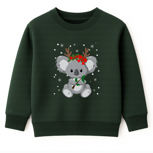Kids dark green Christmas sweatshirt featuring a cute koala wearing reindeer antlers and holly, surrounded by snowflakes, printed on the front. 