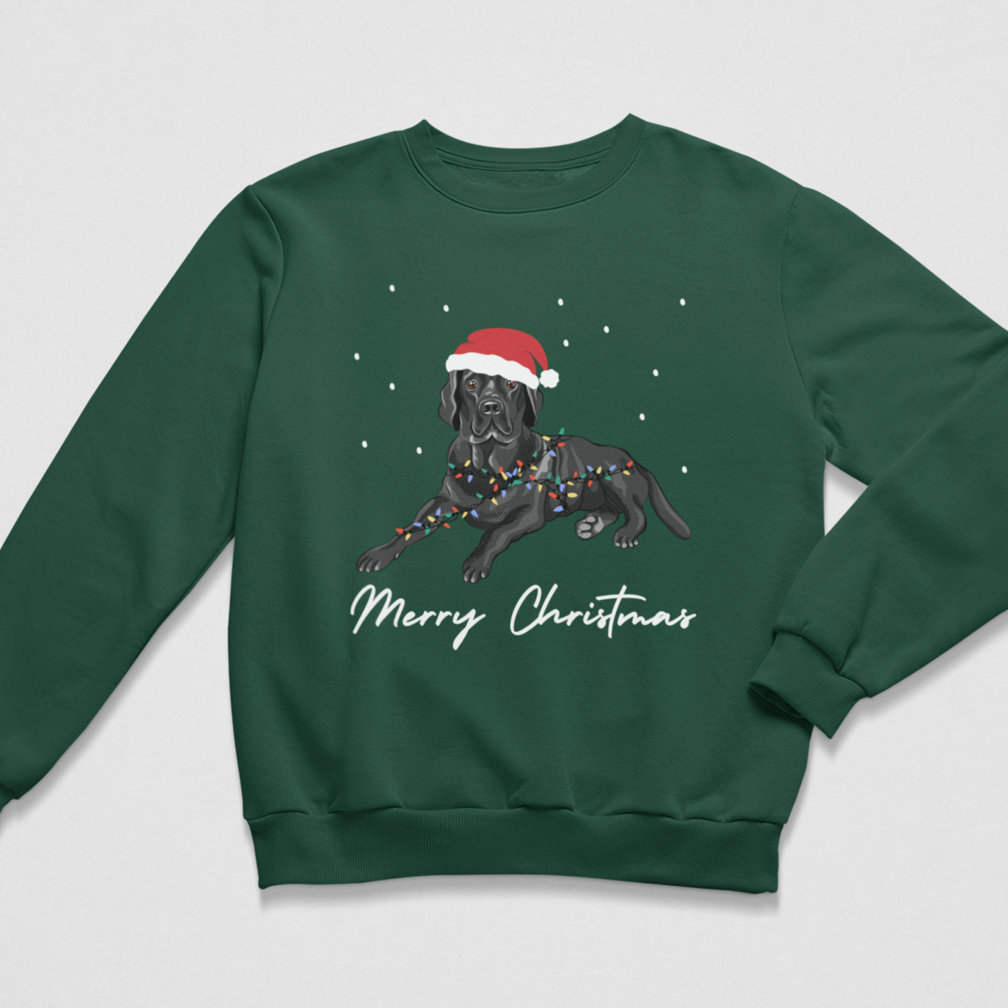 A kids dark green crewneck sweatshirt featuring a graphic of a black Labrador wearing a red Santa hat and holiday lights, with 'Merry Christmas' written in white script below, shown on a light grey background.