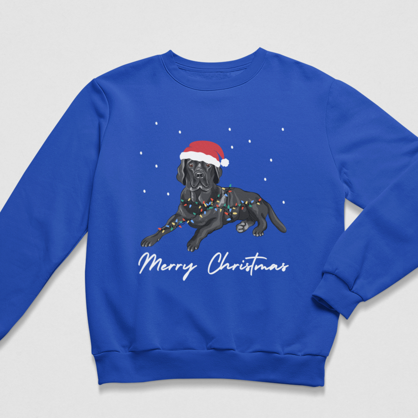 A kids royal blue crewneck sweatshirt featuring a graphic of a black Labrador retriever wearing a red Santa hat and Christmas lights, with 'Merry Christmas' written in white script below, displayed on a light grey background.