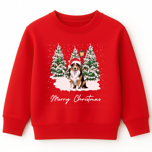 Kids red Christmas sweatshirt with Rough Collie dog in Santa hat, snowy trees and “Merry Christmas” text.