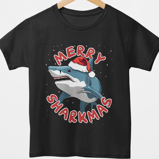 Black t-shirt with a shark wearing a Santa hat and 'Merry Sharkmas' text on a wooden hanger