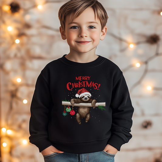 A child wearing a black sweatshirt with a graphic of a sloth wearing a Santa hat, surrounded by festive ornaments, and the text 'Merry Christmas!'