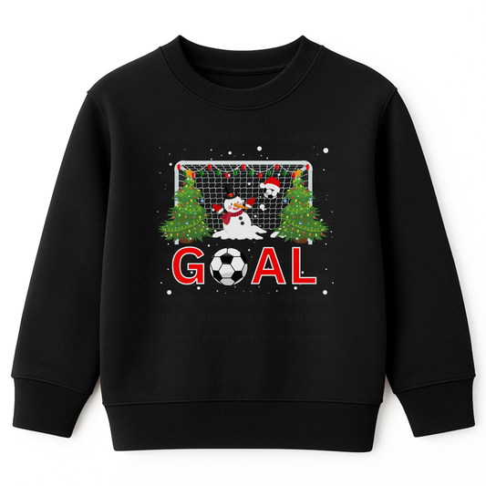 Kids black Christmas sweatshirt featuring a festive football goal scene with decorated Christmas trees, a melting snowman goalie, Santa hat, and the word “GOAL” in bold red letters with a football as the letter “O,” surrounded by falling snow.