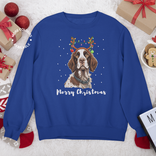 A royal blue long-sleeved sweatshirt with a graphic of a Springer Spaniel wearing antlers and festive lights, and the text 'Merry Christmas'.