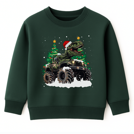 Kids dark green Christmas sweatshirt featuring a T-Rex wearing a Santa hat driving a camo monster truck through snow, with decorated Christmas trees in the background.