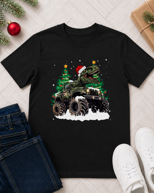 Kids black cotton t-shirt featuring a graphic of a Christmas-themed T-rex dinosaur in a Santa hat, with a decorated Christmas trees and snow - styled with jeans and trainers