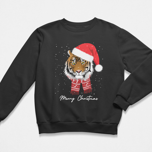 A kids black crewneck sweatshirt featuring a graphic of a tiger wearing a red Santa hat and scarf, with 'Merry Christmas' written below in white script, shown against a light grey background.