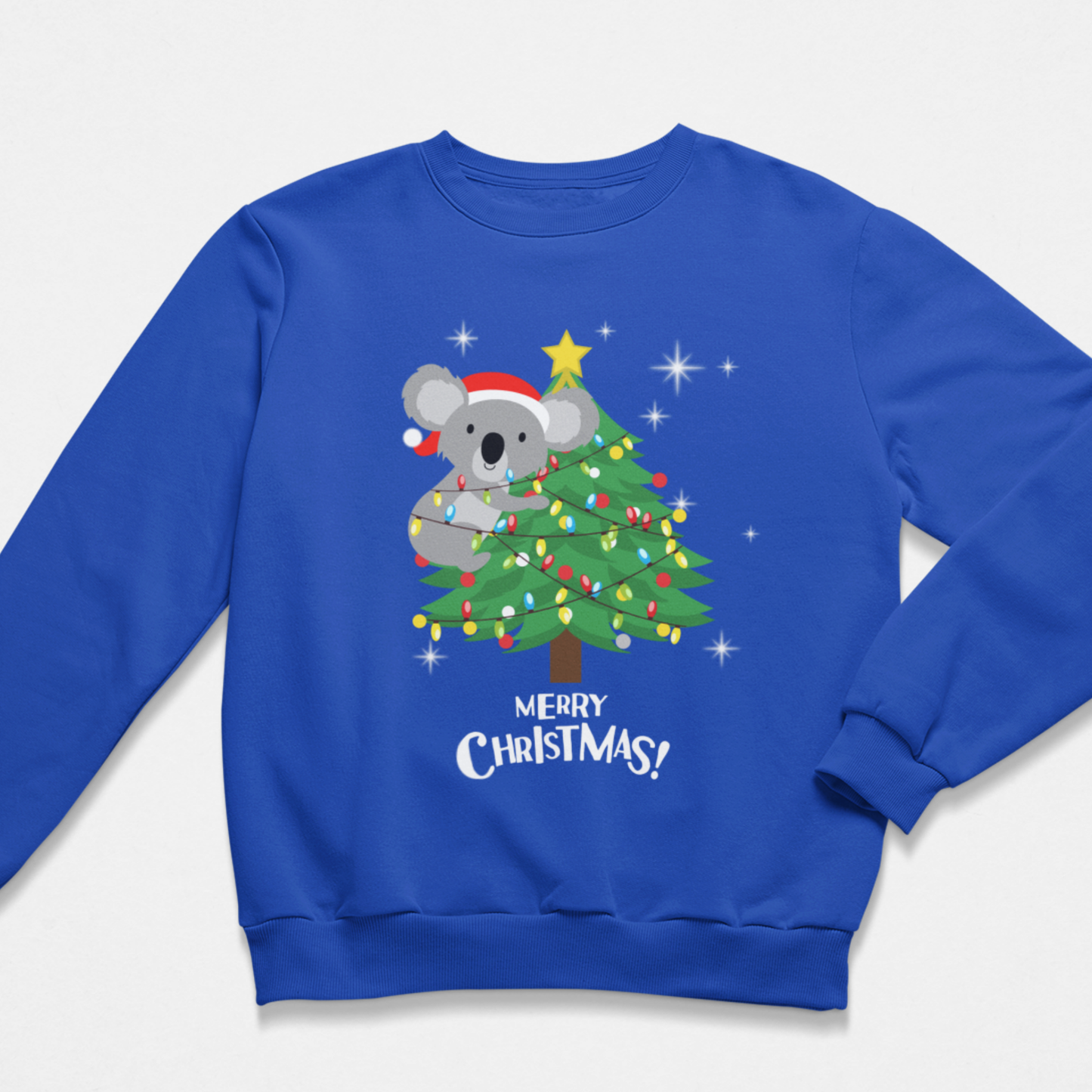 A kid royal blue crewneck sweatshirt featuring a festive Christmas graphic of a koala wearing a Santa hat and hugging a decorated tree with the text 'MERRY CHRISTMAS!' printed below.