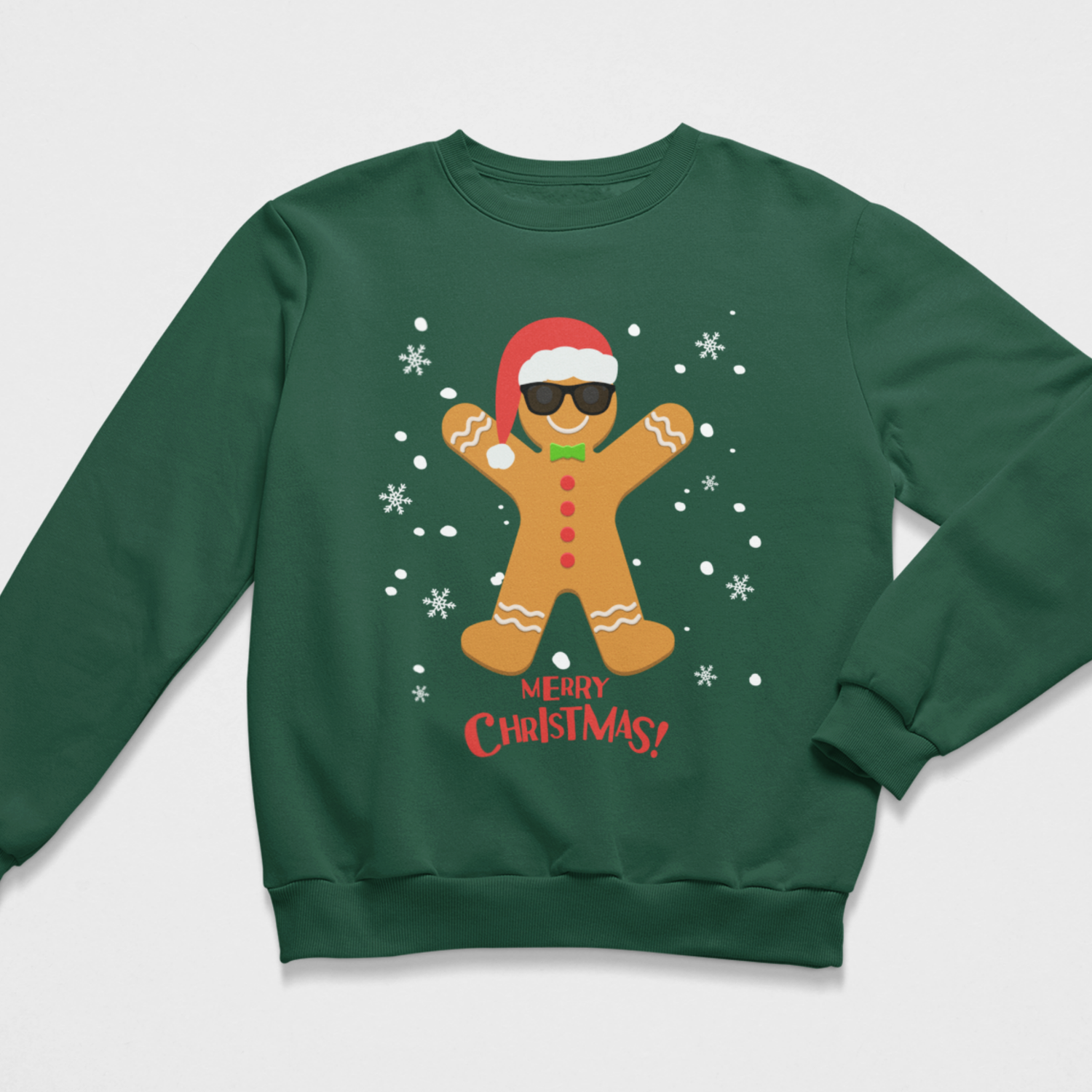 Dark green kids Christmas jumper featuring a gingerbread man wearing sunglasses and a Santa hat with falling snow and Merry Christmas text.