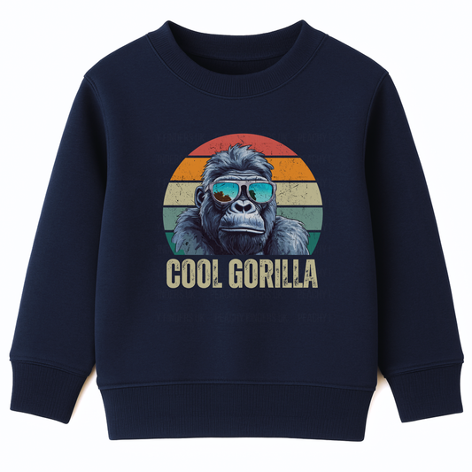 Kids navy sweatshirt featuring a circular graphic of a cool gorilla wearing blue reflective sunglasses. The background is a retro sunset with orange, yellow, and green stripes. Below the gorilla, the text 'COOL GORILLA' is printed."