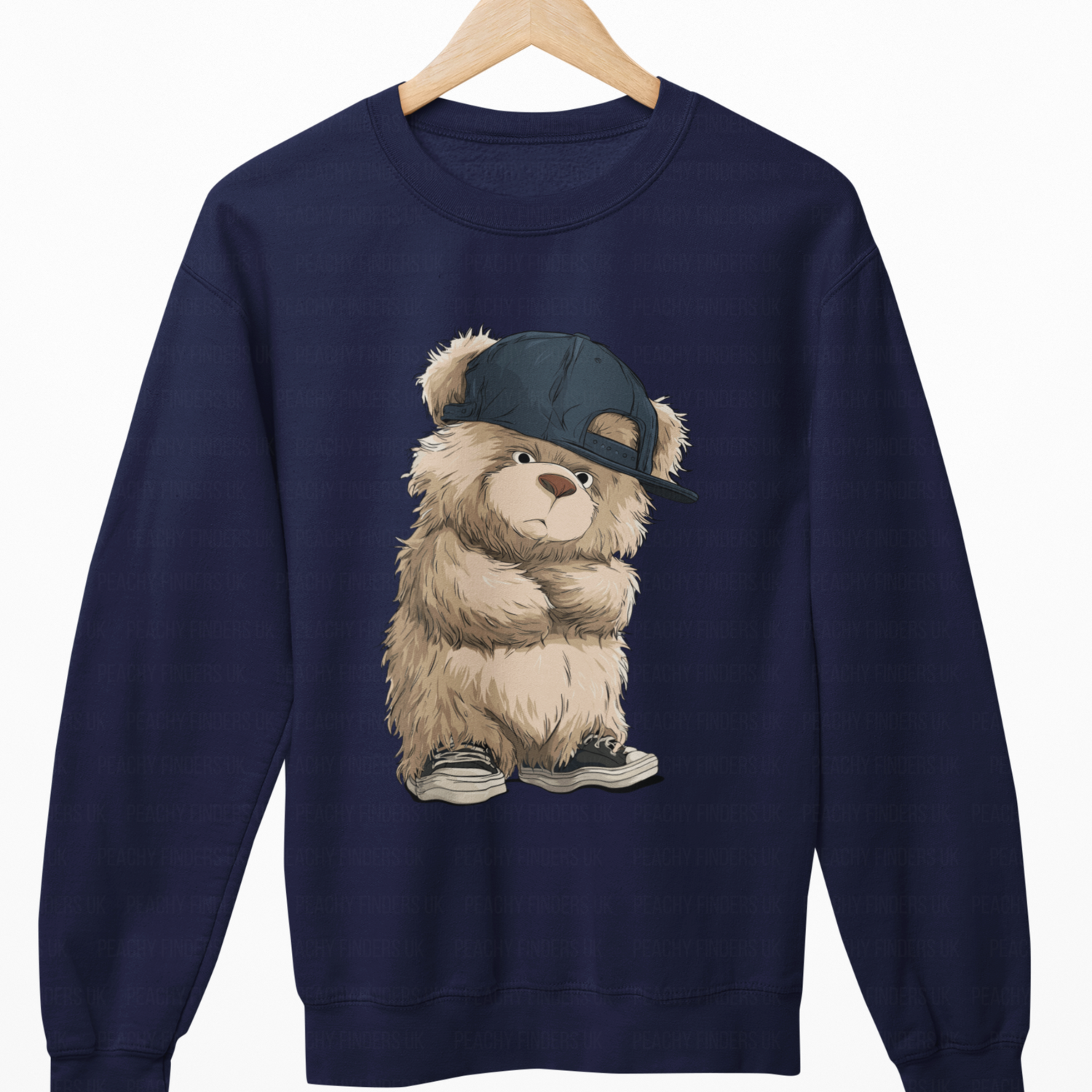 Navy blue sweatshirt with a teddy bear wearing a cap on a white background