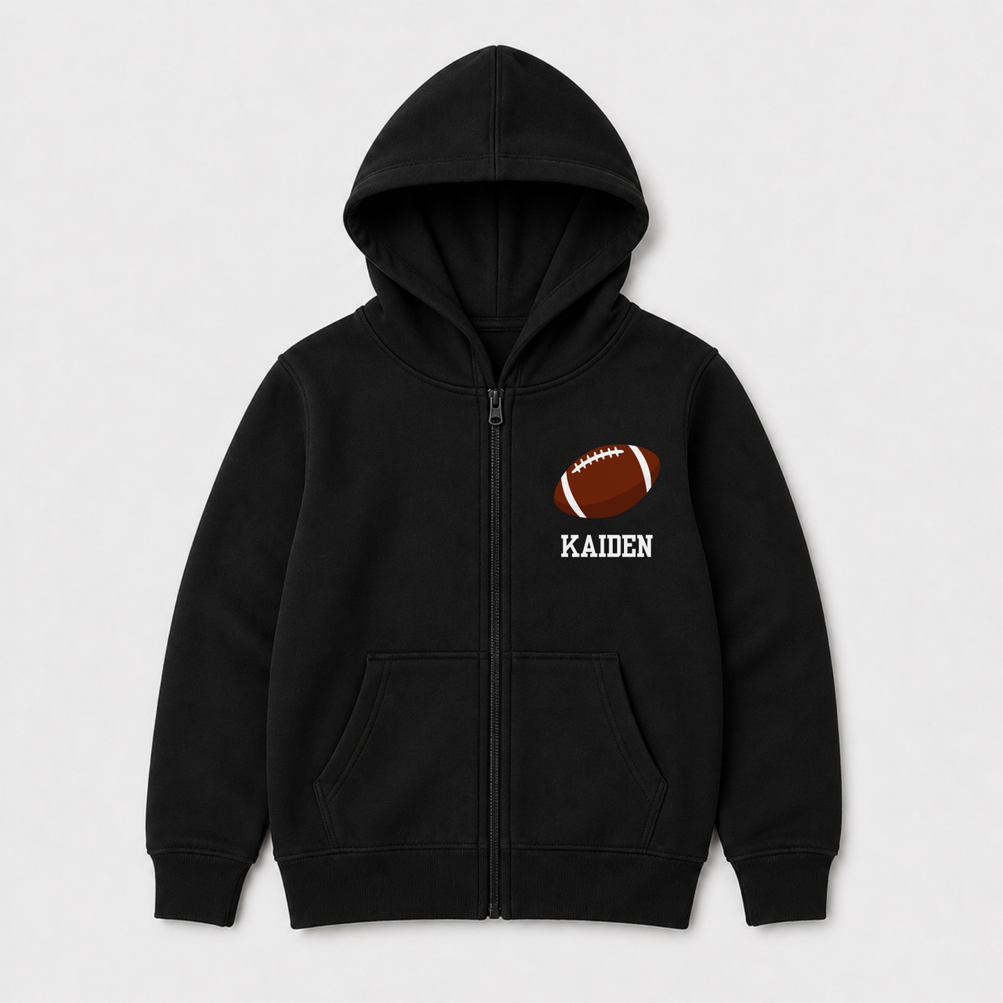 Kids personalised American football zip hoodie in black with custom name and brown football chest graphic, ideal for young sports fans.