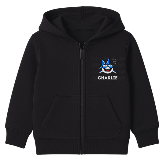 Kids black zip-up hoodie featuring a small cool cartoon shark wearing sunglasses with personalised name ‘Charlie’ printed on the chest."