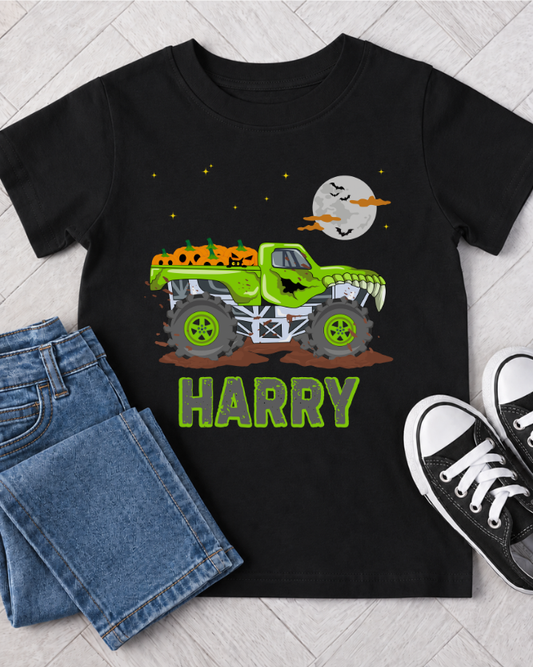 Kids personalised Halloween monster truck t-shirt flat lay with jeans and trainers featuring custom name and spooky green truck design