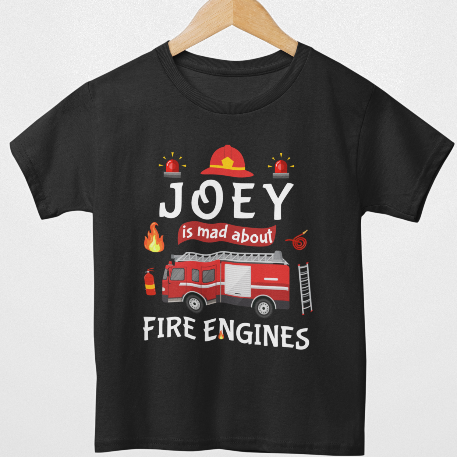Styled on a wooden hanger a kids black T-shirt with red fire engine, firefighter icons and personalised text Joey is mad about fire engines printed on the front.
