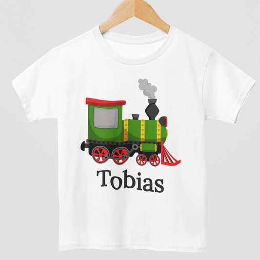 Close up of kids personalised steam train t-shirt with green and red locomotive graphic - white tee styled on a wooden hanger.