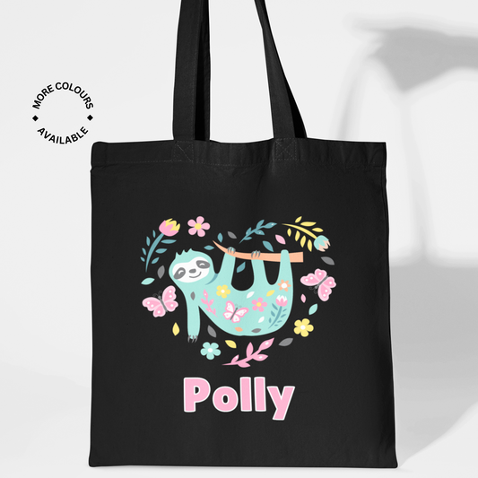 Girls black cotton tote bag with a printed design of a colourful sloth, flowers, and butterflies. Custom-name 'Polly' printed in pink and white underneath
