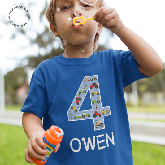 A royal blue boys personalised birthday t-shirt with tractors in the shape of a number 