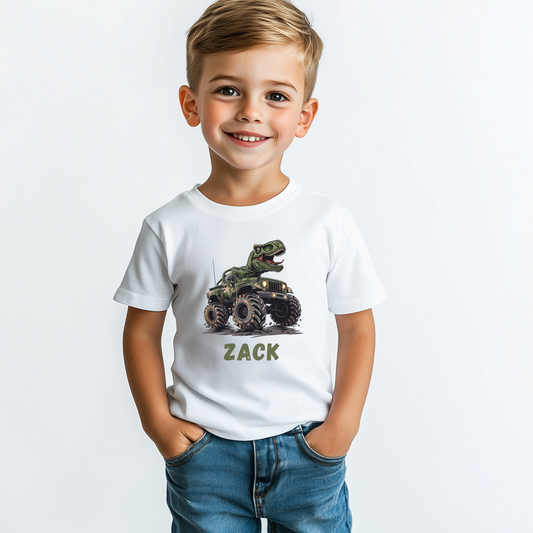 Little boy wearing a white short sleeve t-shirt with a printed T-rex riding on  a monster truck