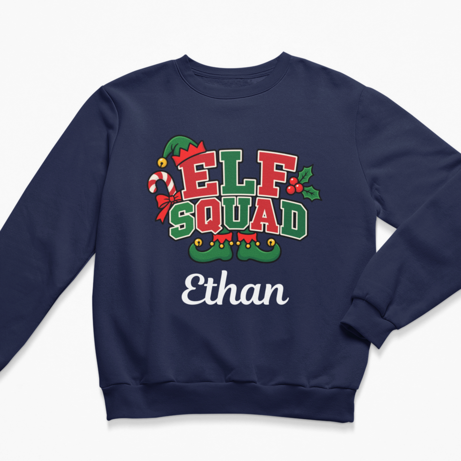 Flat lay of a navy blue kids' Christmas crewneck sweatshirt featuring a colourful "ELF SQUAD" graphic with candy canes and festive elf footwear, personalised with the name "Ethan" in cursive text