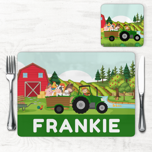 Personalised kids farm placemat and coaster set with green tractor, barn and farm animals, name “Frankie” printed along the bottom.