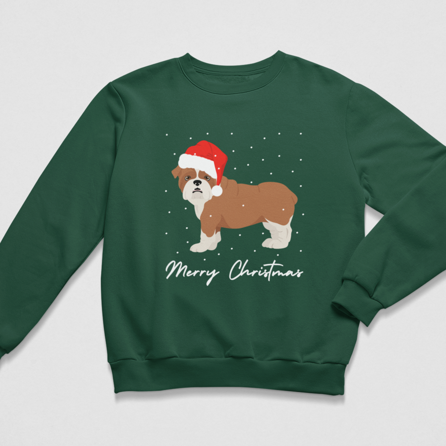 A kids dark green crewneck sweatshirt featuring a graphic of a brown and white dog wearing a red Santa hat, surrounded by white snowflakes, with 'Merry Christmas' written in white script below. The sweatshirt is displayed flat against a light grey background.