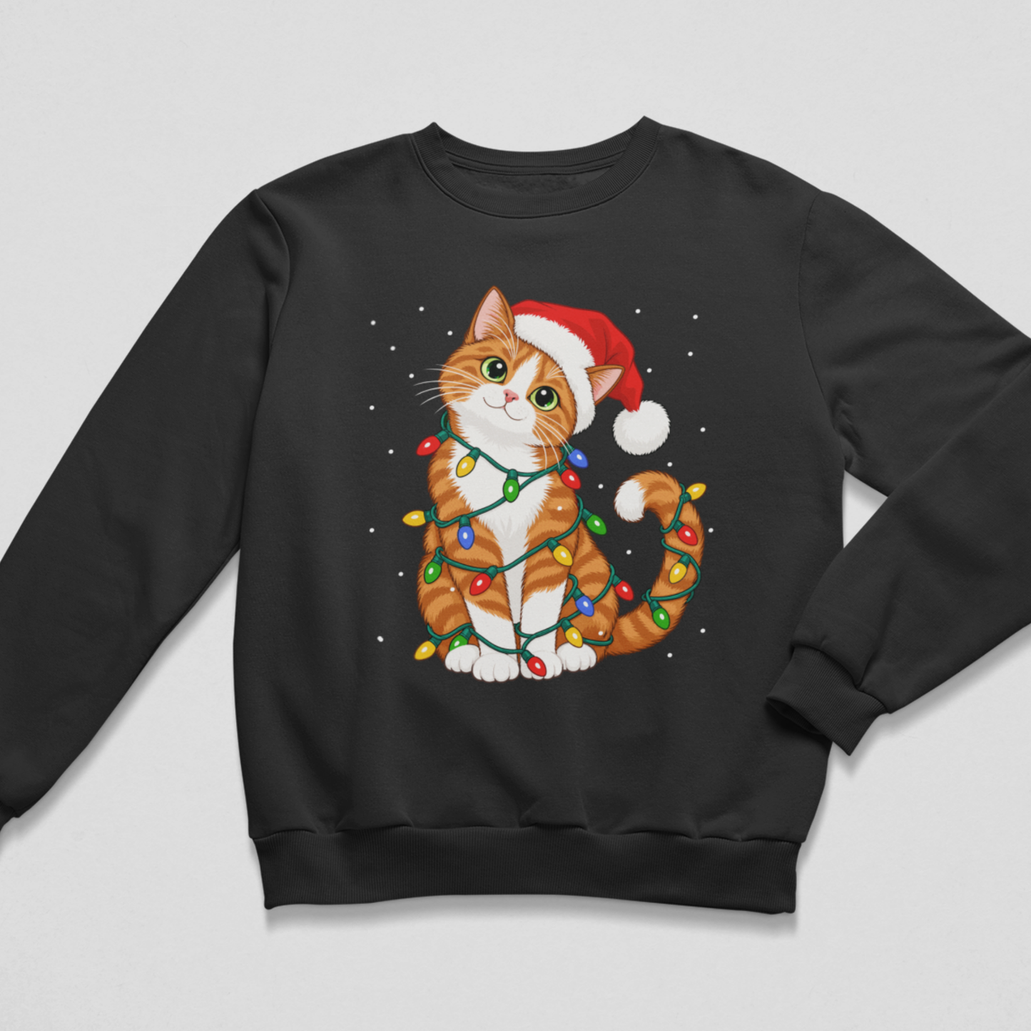 Flat lay of a black kids' Christmas crewneck sweatshirt featuring a graphic of an orange and white tabby cat wearing a red Santa hat and wrapped in multicoloured Christmas lights, displayed on a light grey background.