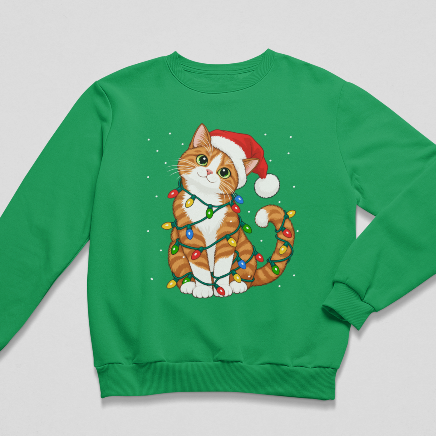 lat lay of a bright kelly green kids' Christmas crewneck sweatshirt featuring an illustration of a ginger and white cat in a Santa hat tangled in bright Christmas tree lights.