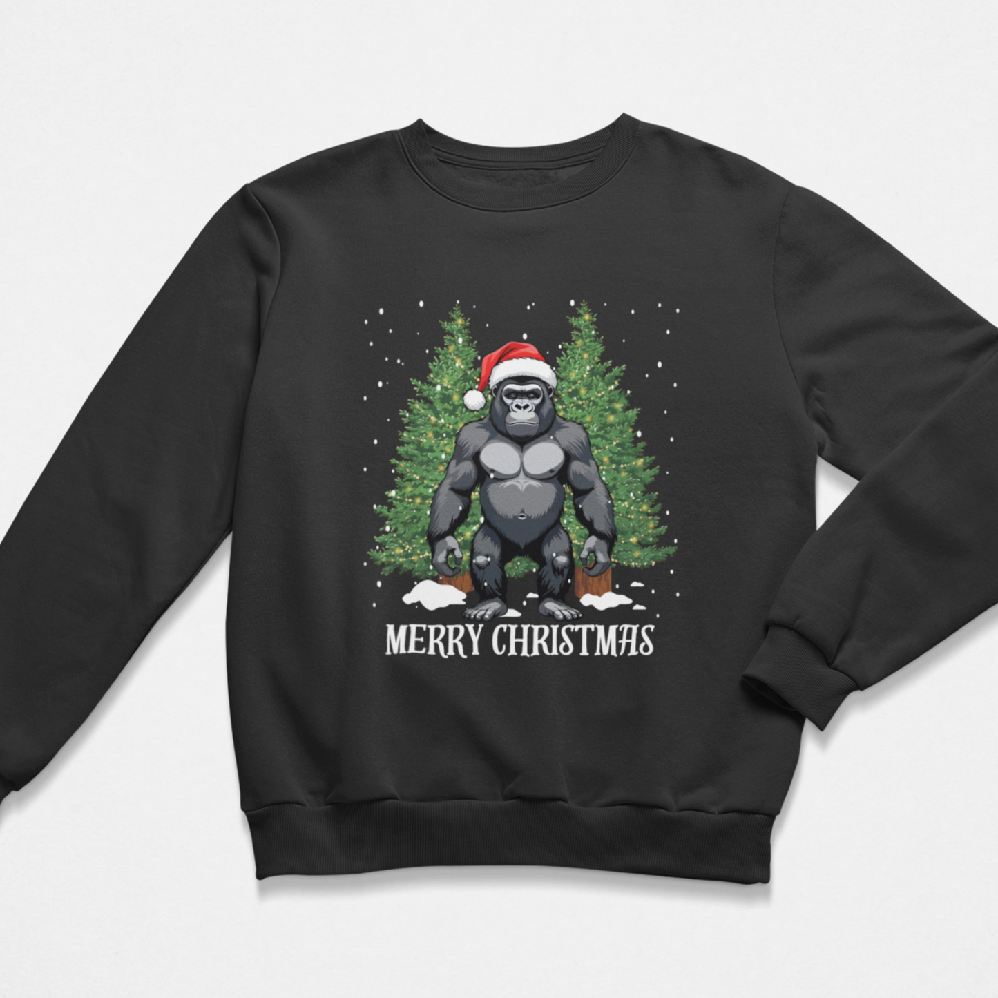 A kids crewneck sweatshirt in black featuring a graphic of a gorilla wearing a Santa hat in front of a Christmas trees and falling snow with 'MERRY CHRISTMAS' printed below.