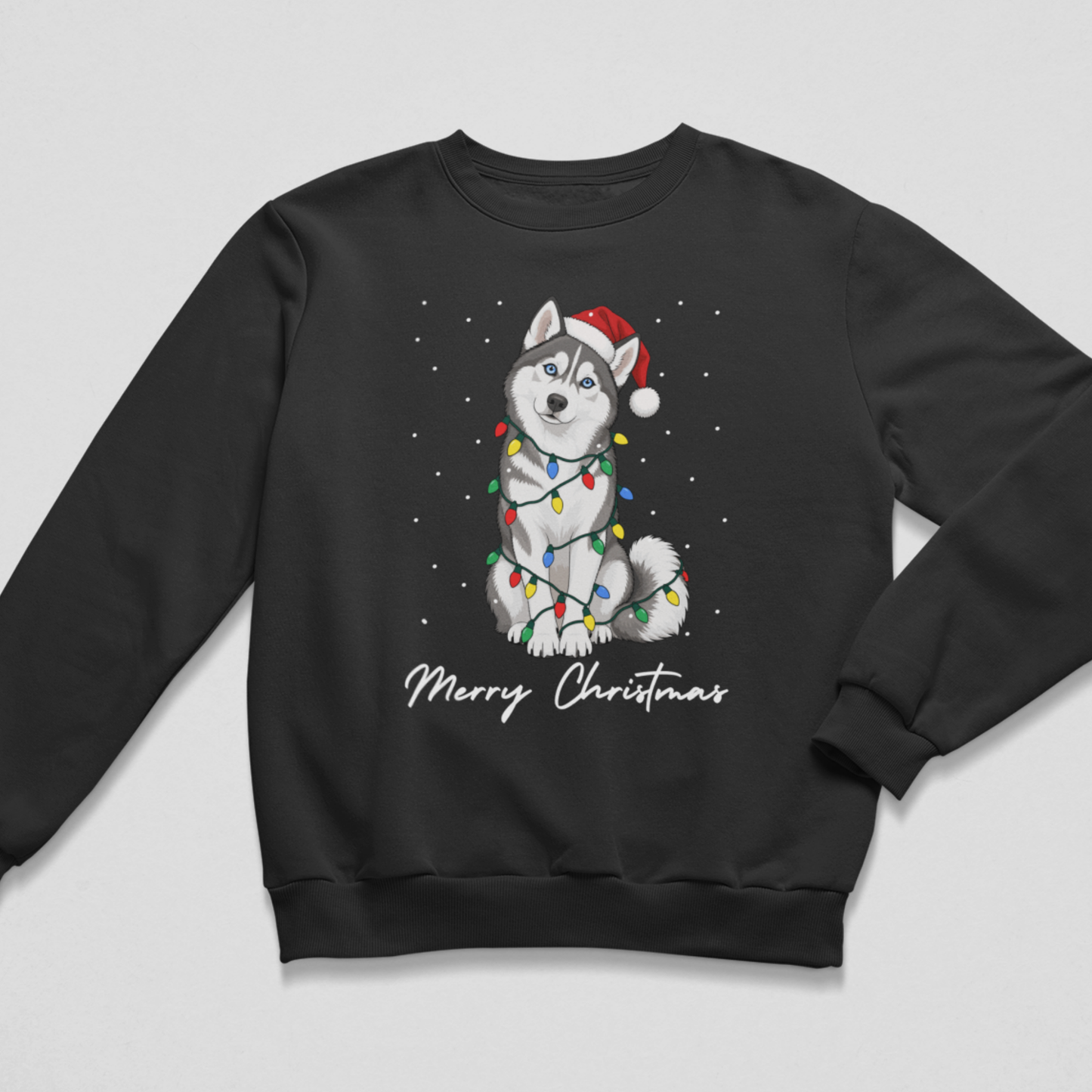Kids’ black Christmas sweatshirt laid flat, featuring a grey and white husky in a Santa hat, colourful lights and Merry Christmas lettering.