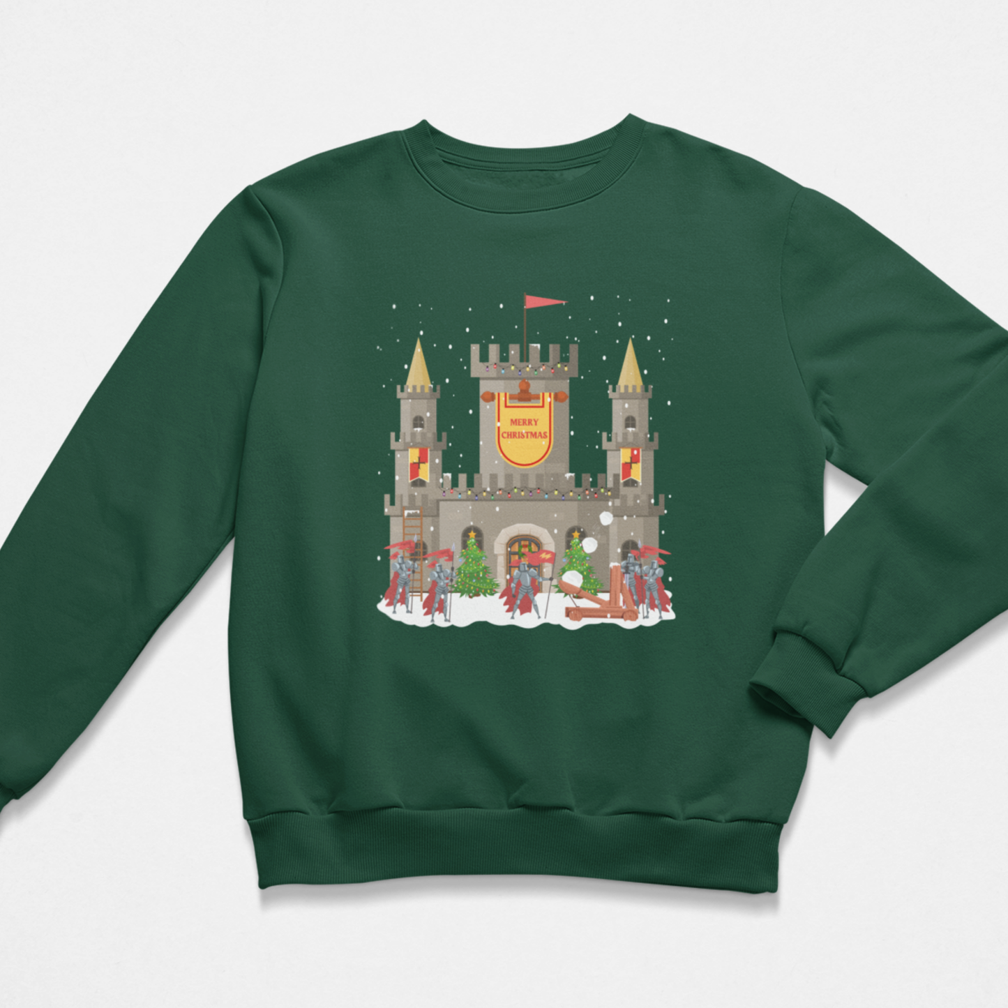 Dark green kids Christmas sweatshirt showing a snowy stone castle with “Merry Christmas” banner, golden turrets, red-armoured knights, catapult and festive trees on the front.
