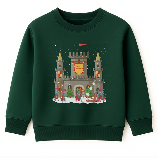 Dark green kids Christmas sweatshirt showing a snowy stone castle with “Merry Christmas” banner, golden turrets, red-armoured knights, catapult and festive trees on the front.